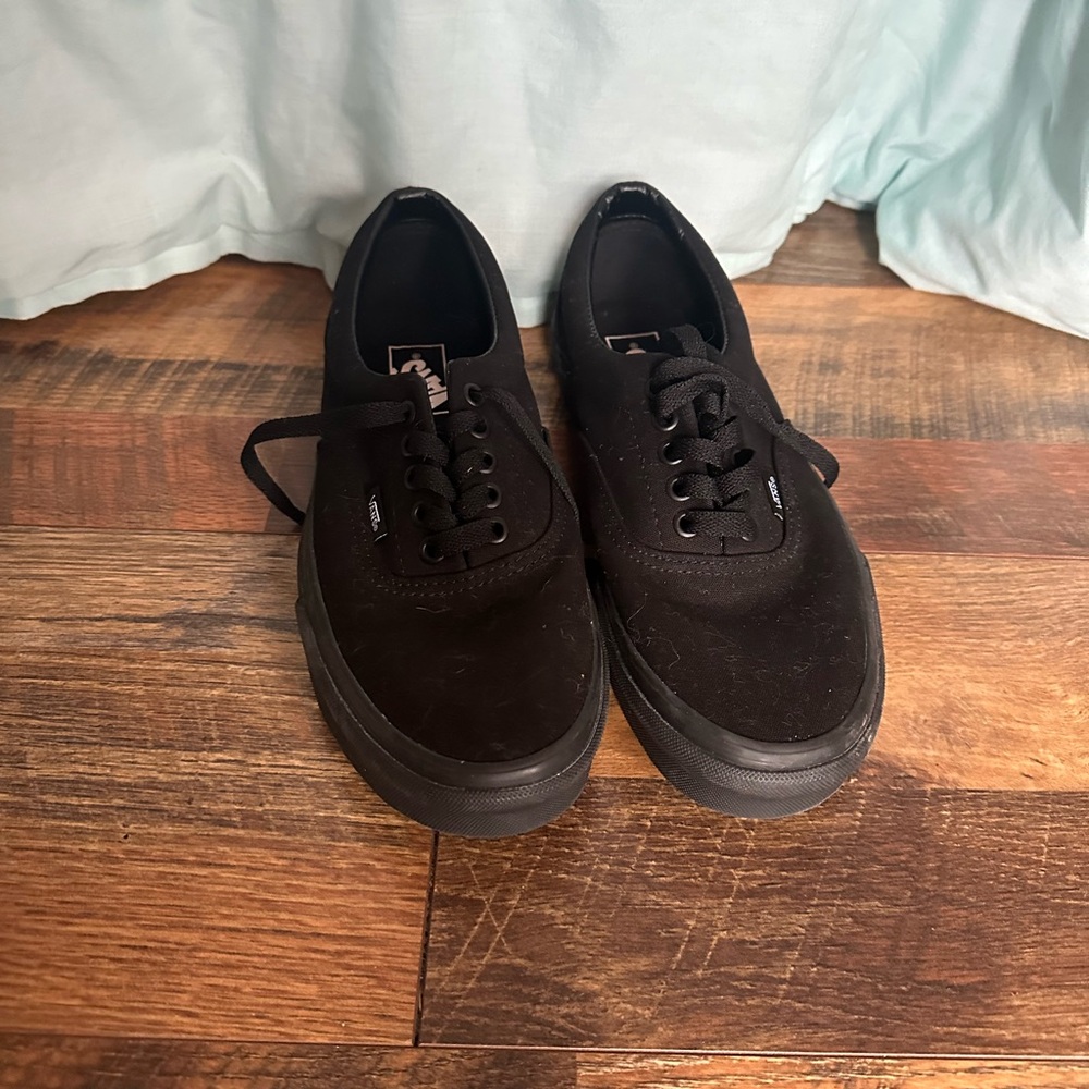 Black unisex Vans.